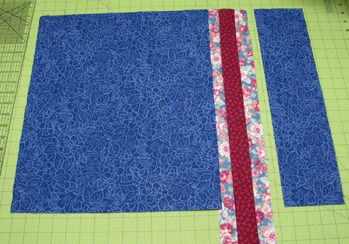 Add the pieced section to the blue fabric and then add the other blue piece