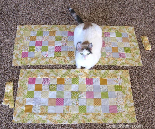 Orange Kissed Tablerunners tutorial fabric piecing the table runners and a cat on them