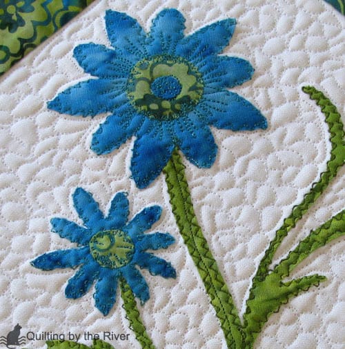 Free motion applique stitching on a batik table runner