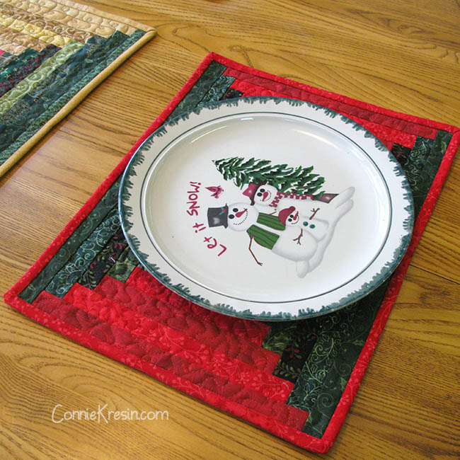 Christmas quilted log cabin placemats in a courthouse design