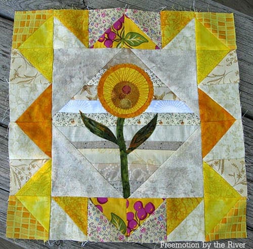 Scrappy Yellow quilt block with applique flower