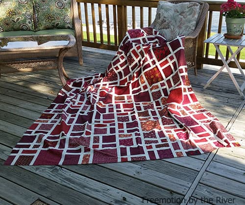 Scattered quilt in red fabrics