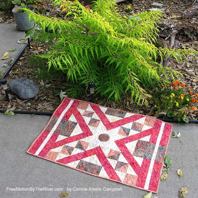 Indian Sunset quilt by a beautiful fern