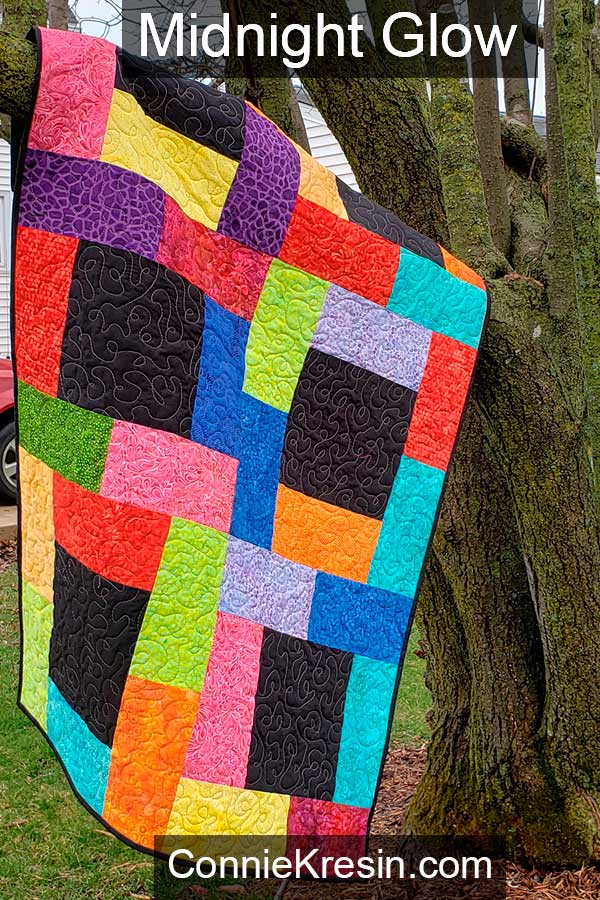Learn how to make the Midnight Glow lap quilt tutorial made with rainbow quilt fabrics