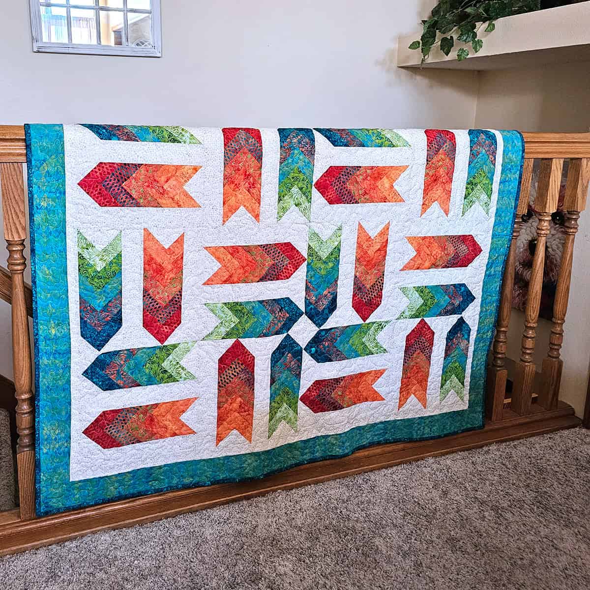 Fletching quilt hanging on stair rail