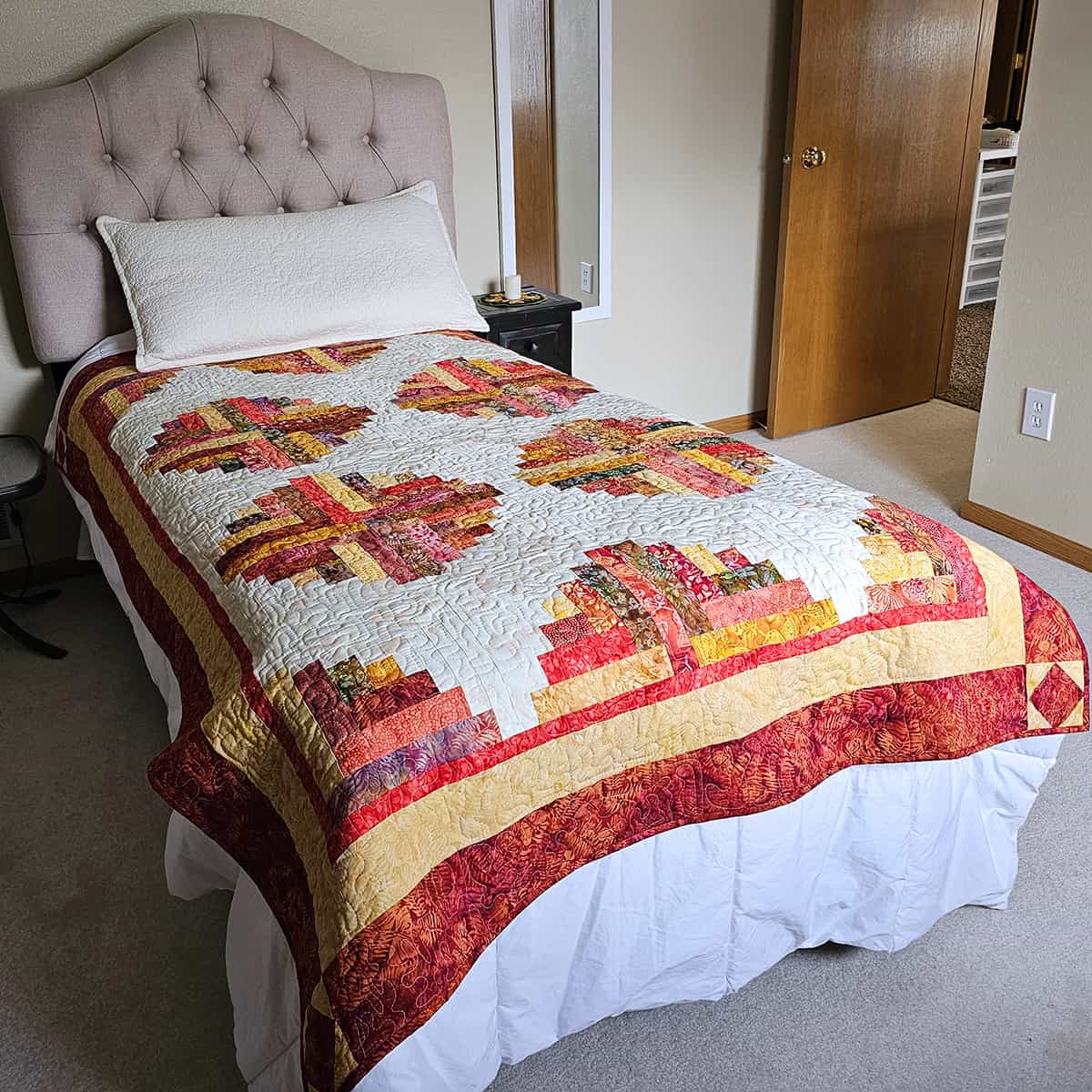 Mirage log cabin quilt on a twin bed