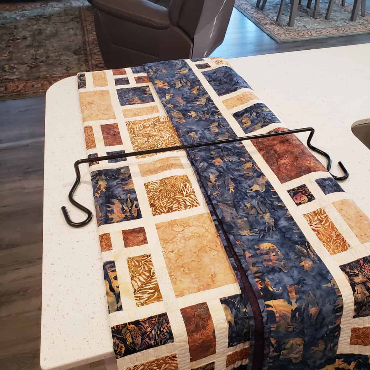 Putting the quilt on the quilt keeper bar