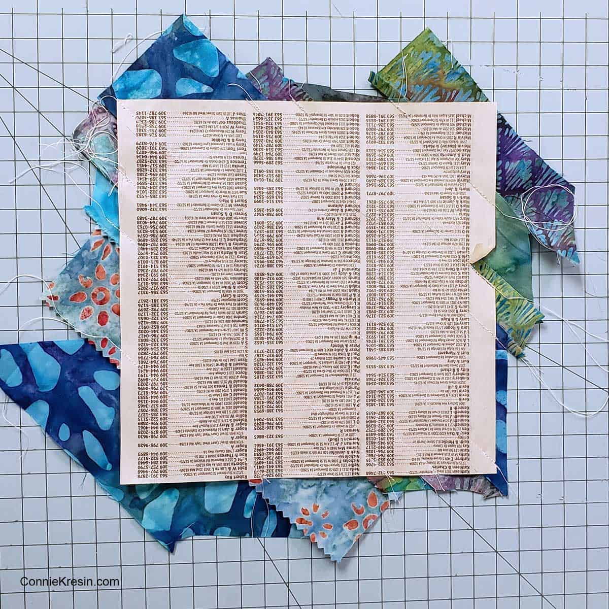 Cover the paper with the fabric strips