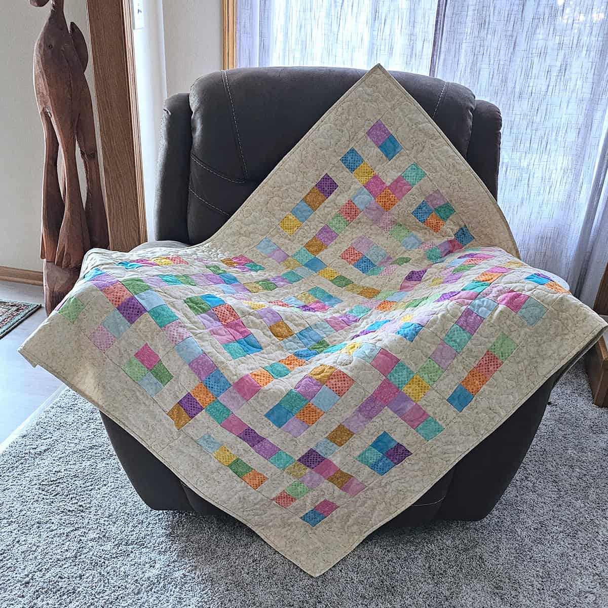 Hopscotch baby quilt on chair
