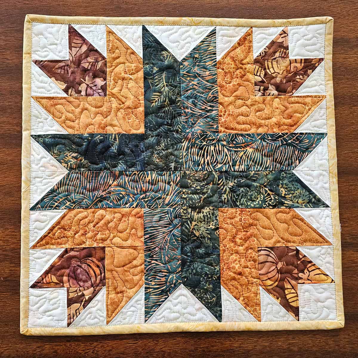 "Cactus Flower” is a Free Autumn Quilted Table Topper Pattern designed by Connie Kresin Campbell from Freemotion by the River!