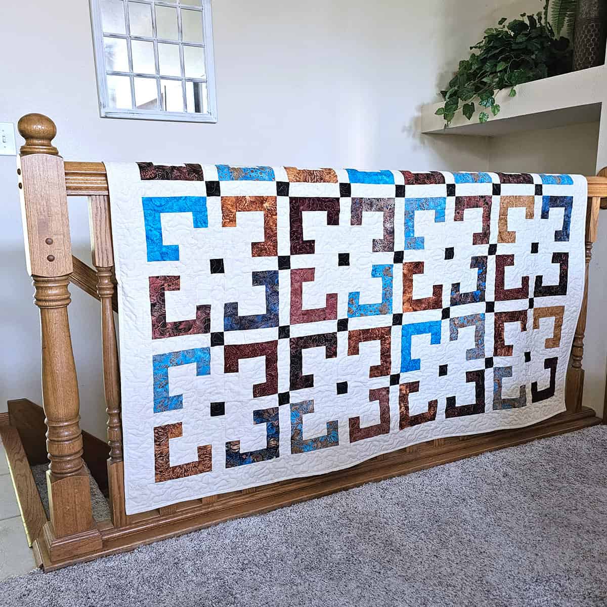 Rustic Riches quilt on stair railing