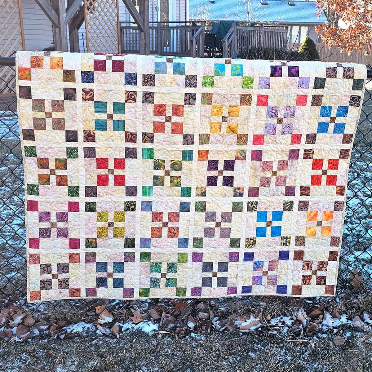 Quilt outside on fence
