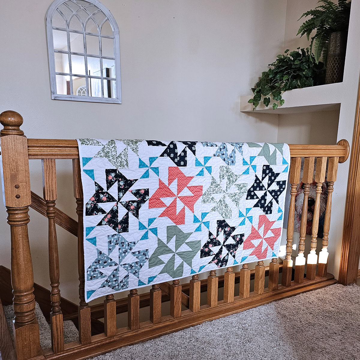 Snowdrift quilt hanging on the stair rail