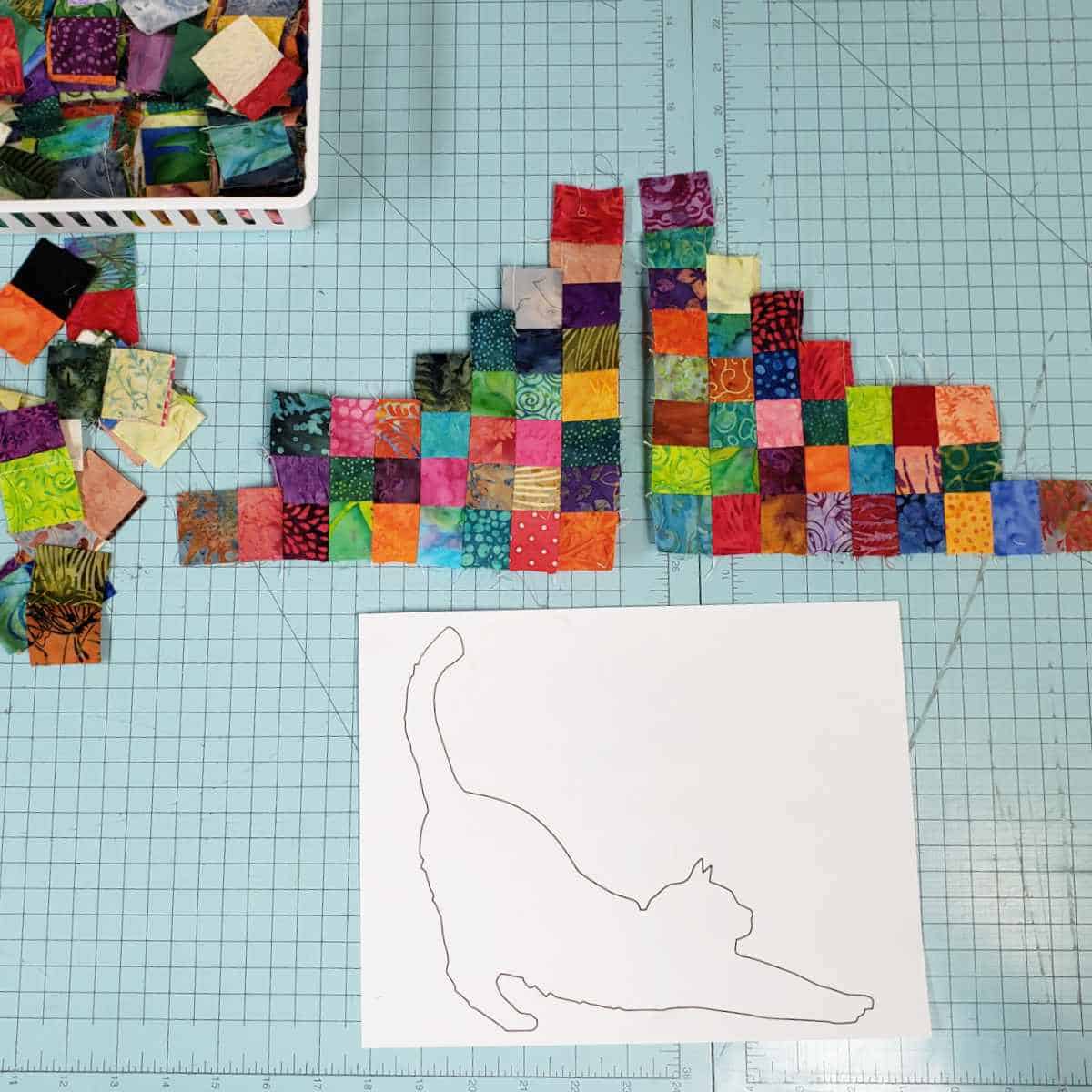 Laying out the squares to cover the cat applique