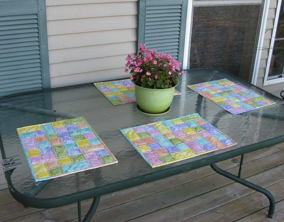 Four placemats on glass table