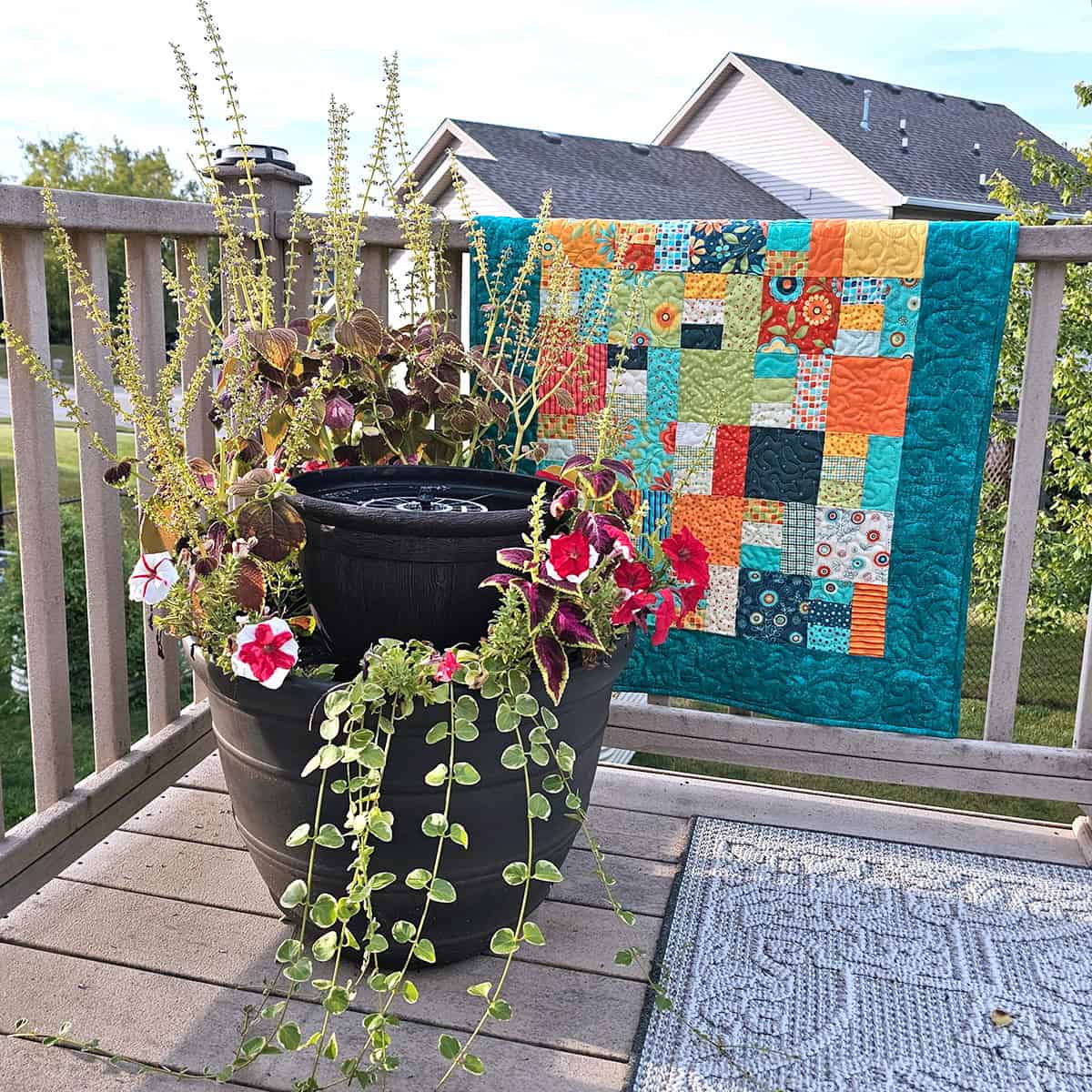 Scrappy quilt by water fountain